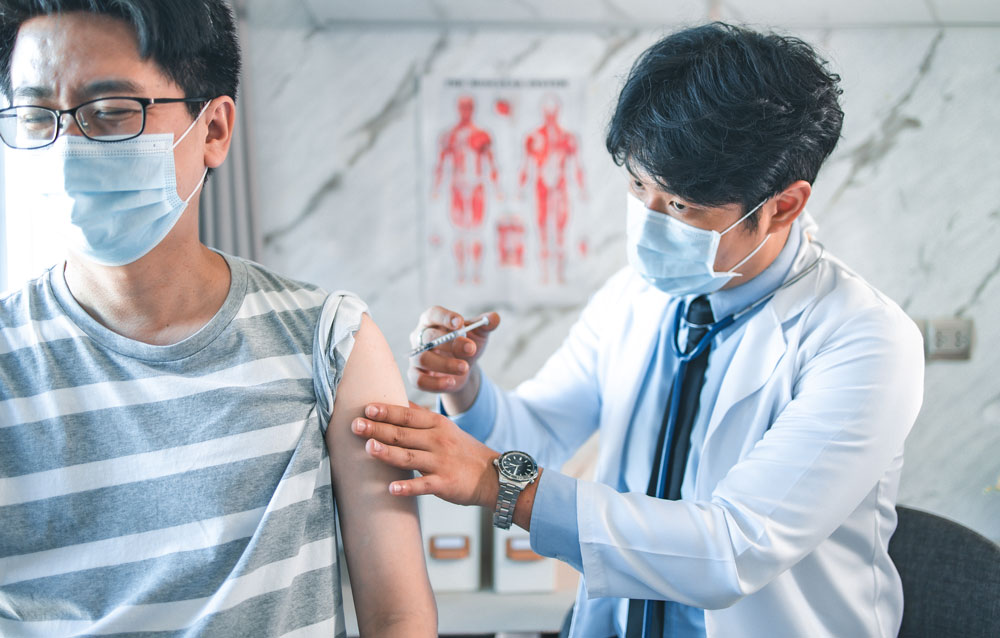 doctor giving a patient flu vaccination