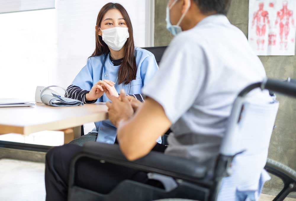female healthworker speaking with a male patient