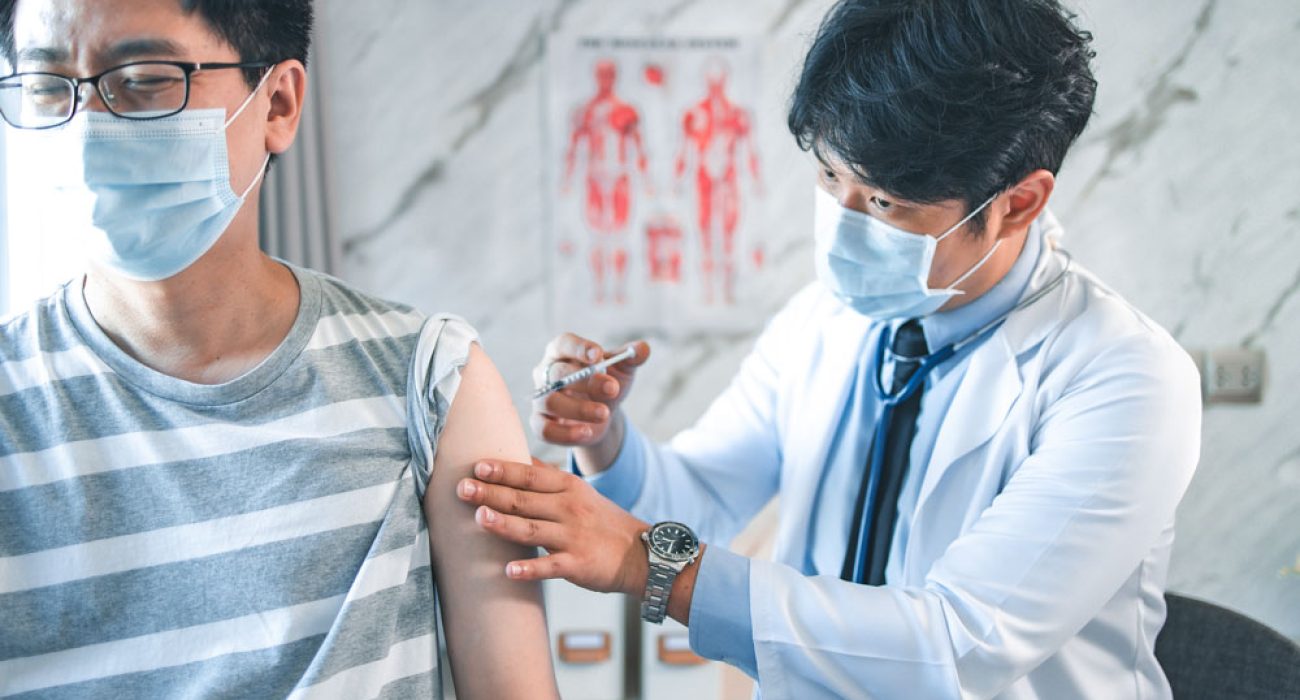 doctor giving a patient flu vaccination